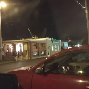 a red car parked in front of it