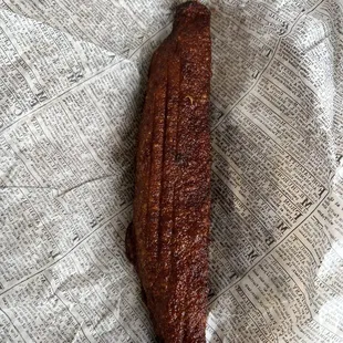 a piece of meat on a newspaper