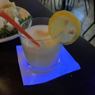 a glass of lemonade and a plate of salad