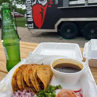 a plate of food and a bottle of beer