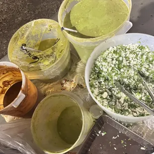 Salsas and onions/cilantro. My fave is the avocado salsa (upper left)