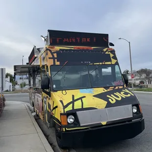 a food truck parked on the side of the road