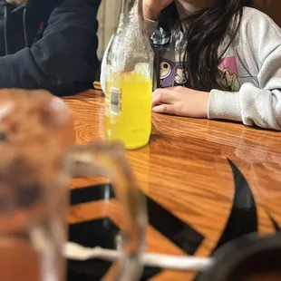 a little girl sitting at a table