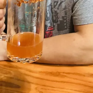 a man holding a glass of beer