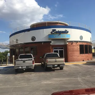 two trucks parked in front of the restaurant