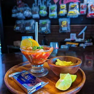 a bowl of fruit and a bag of chips
