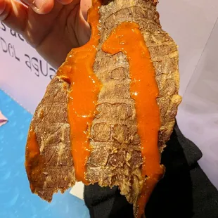 a hand holding a sandwich