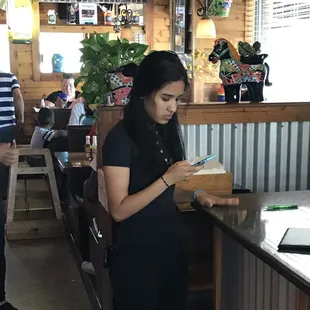 Unfortunately this is probably your waitress... On her phone... While she should be taking your order.