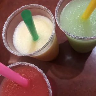 three different drinks with straws