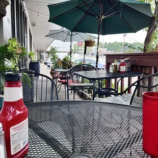 a table and chairs with an umbrella
