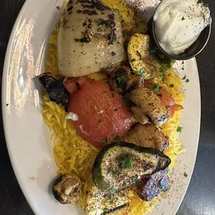 That is a chicken kebab with rice. Yum food!
