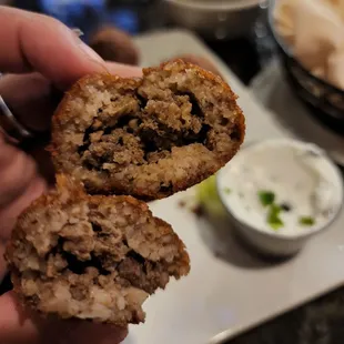 a hand holding a half eaten food item