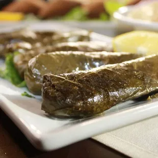 a plate of stuffed grape leaves