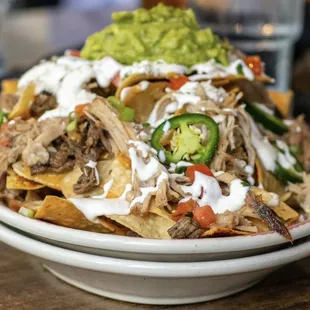 Carnitas and carne asada nachos. Good. GINORMOUS!