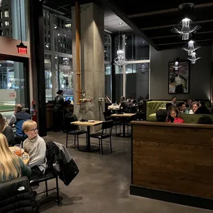 people sitting at tables in a restaurant