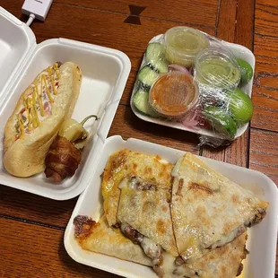 Sonoran hot dog, caramelo, toppings (salsa, lime, onions, cucumber)
