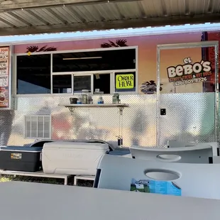 Food cart with four tables and shade.