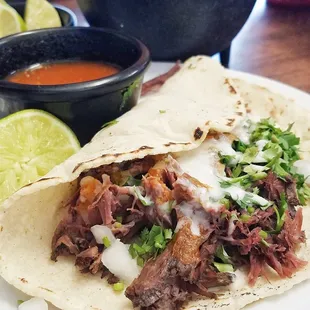 Birria Taco with sour cream sauce
