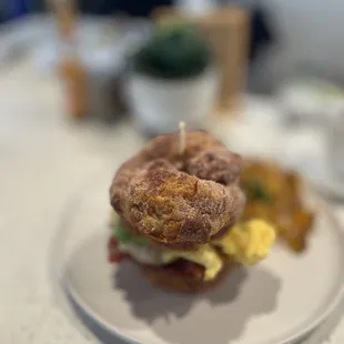 Cinnamon roll sandwich, scrambled eggs, ham, country potatoes