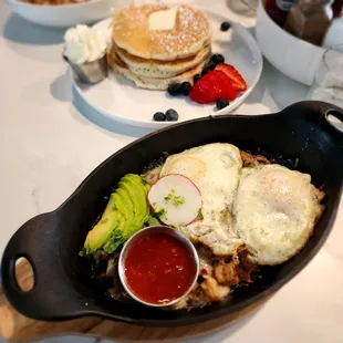 Bottom: Chorizo w/eggs over medium.  Center: Butter pancakes, stack of 3. Top: Chilaquiles w/green sauce and scrambled eggs.