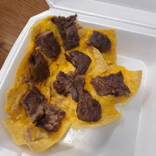 nachos in a styrofoam container