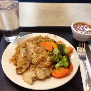 Chicken breast , veggies and rice a beans , decent portion