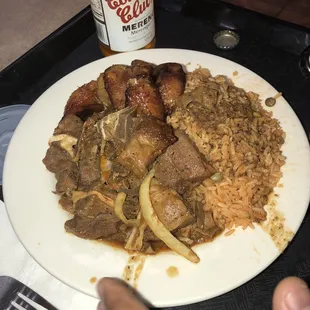 Moro de guandules (yellow rices with pigeon peas), chivo (roasted goat) and sweet platains.