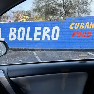 a blue wall with a sign that says cuban food