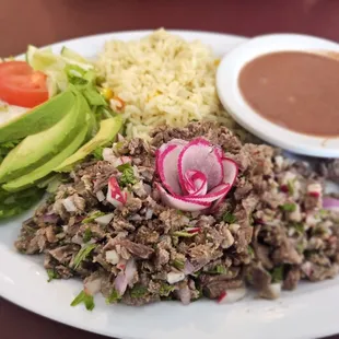 Carne deshilada - shredded beef, beans, and salad