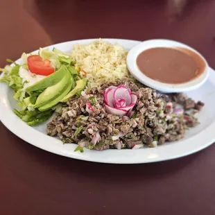 Carne deshilada - shredded beef, beans, and salad