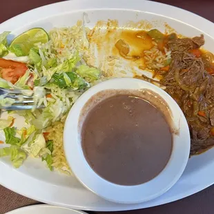 Partially eaten shredded beef plate