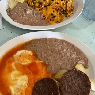 Huevos rancheros with sausage and migas with chorizo added in the back.