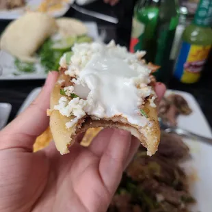 a hand holding a piece of food