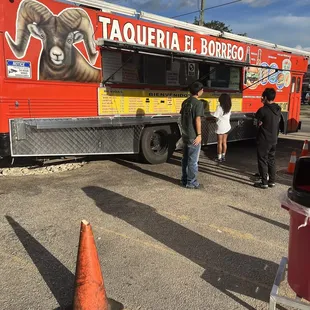 people getting food from a food truck