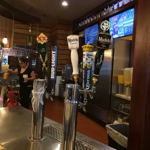 a row of beer taps at a bar