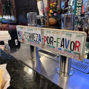 a beer tap with a sign on it