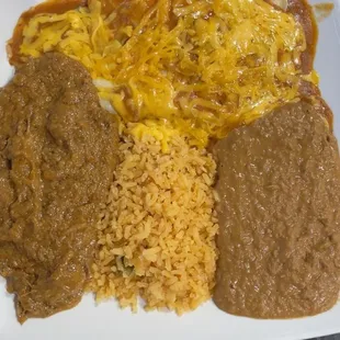 Carne guisada had bites of meats with a thick gravy. Enchiladas lacked flavor. Beans tasted like a mix of can refried beans.