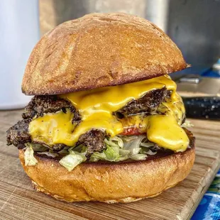 a hamburger with cheese and lettuce