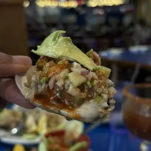 a hand holding a sandwich