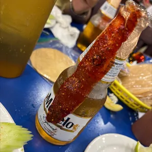 a bottle of beer with a stick sticking out of it