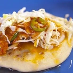 a close up of a taco on a blue plate