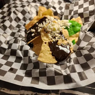 Tortilla with molé, cotilla, and an accompanying avocado based salsa.