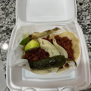 a taco in a styrofoam container