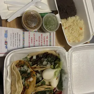 Asada and al pastor tacos with a side of rice and beans