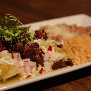 Enchiladas Verdes with Chorizo. Served with beans and rice.