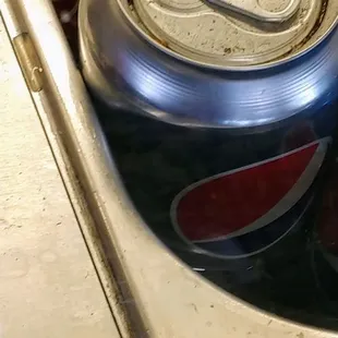 a can of coke in a sink