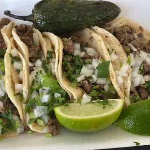 a plate of tacos and a lime