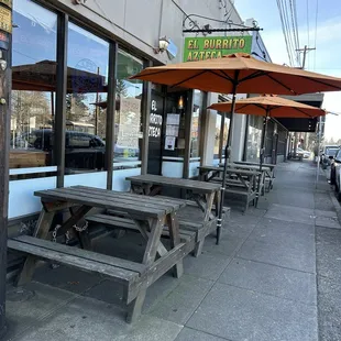 tables and umbrellas on the sidewalk