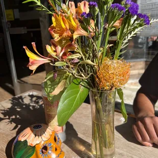 Cute flowers and decor on table.