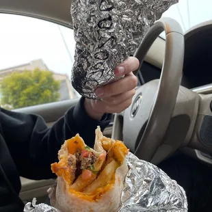 a person holding a burrito
